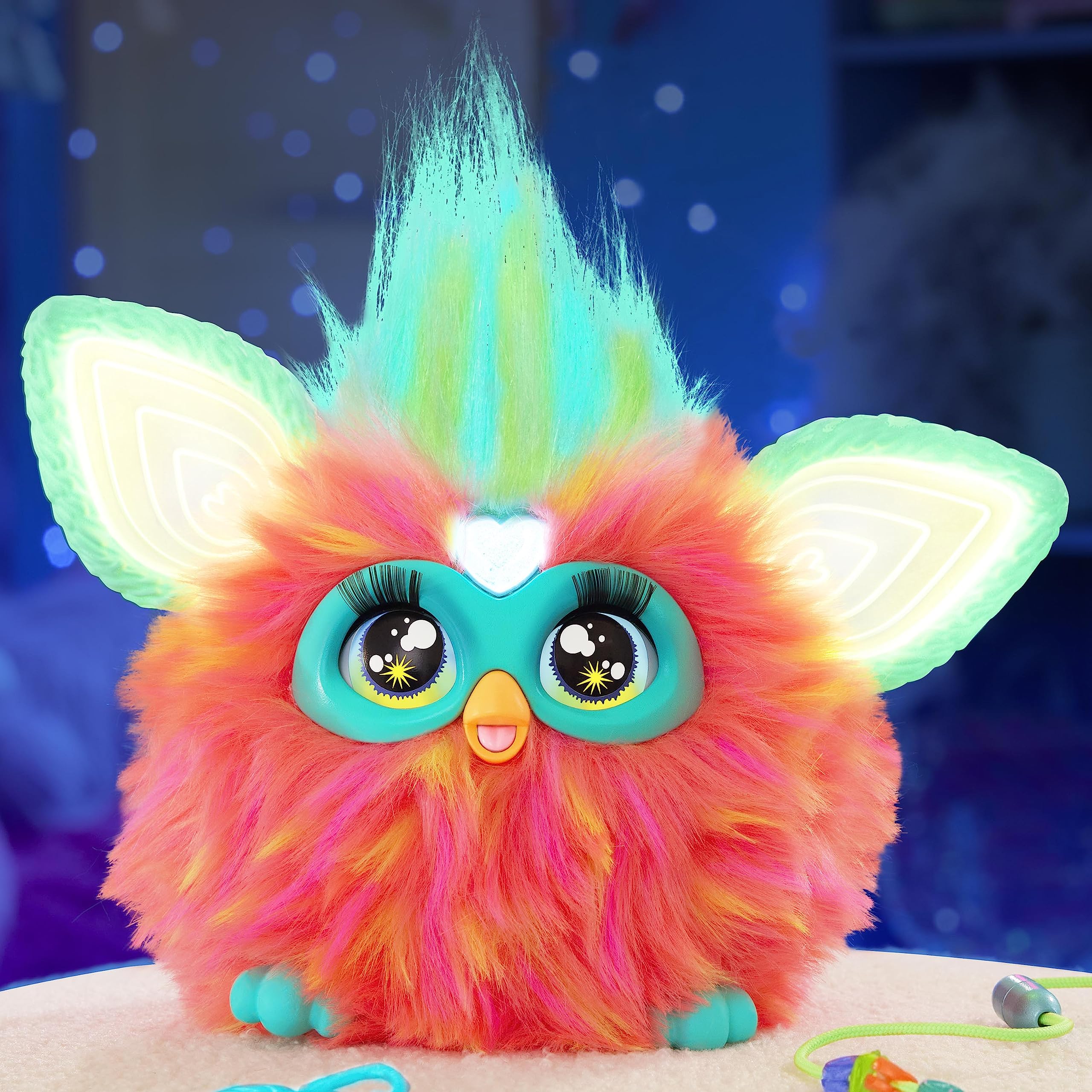 Furby Coral hair grooming with a comb for playful care.