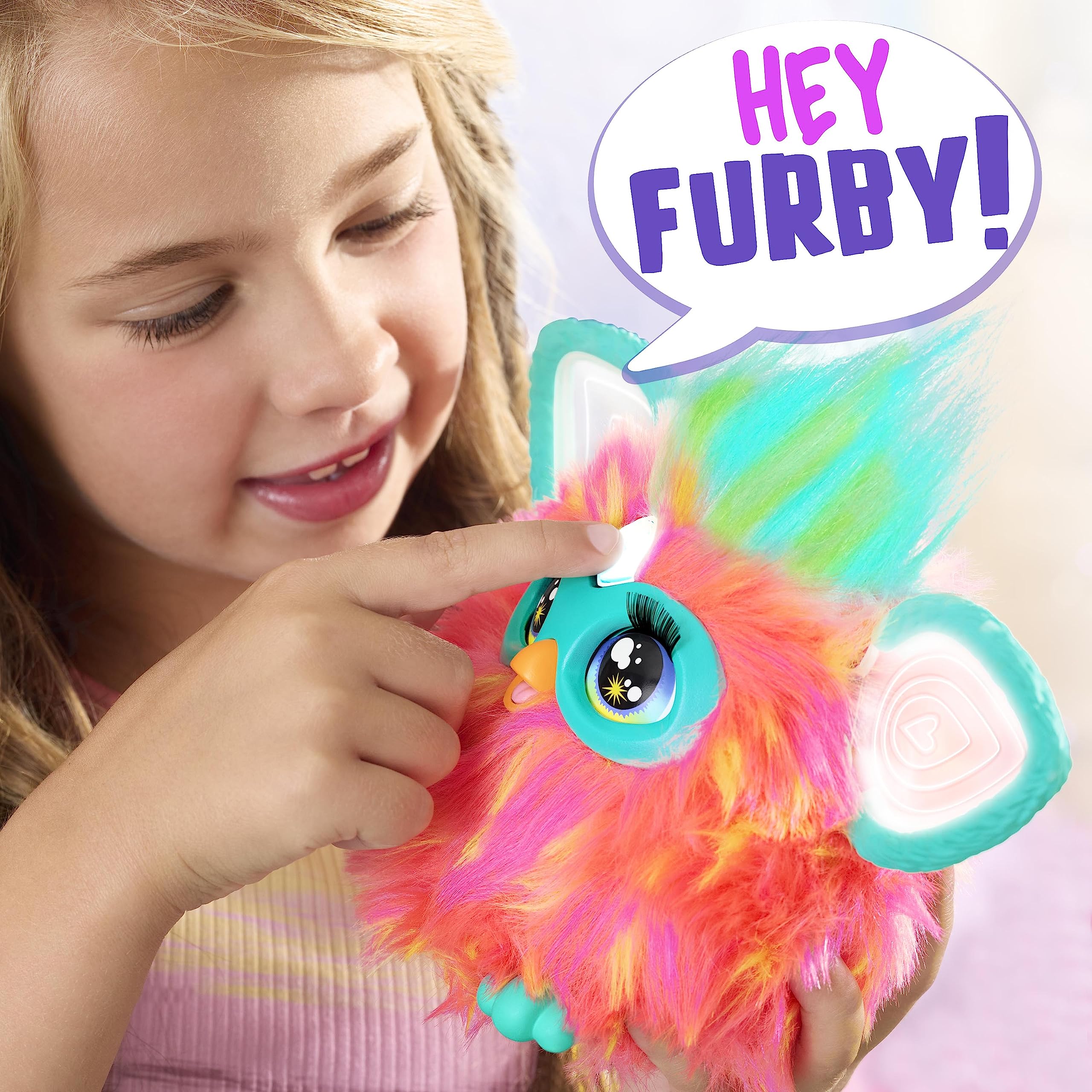 Furby Coral heart gem activates voice commands for interactive play.
