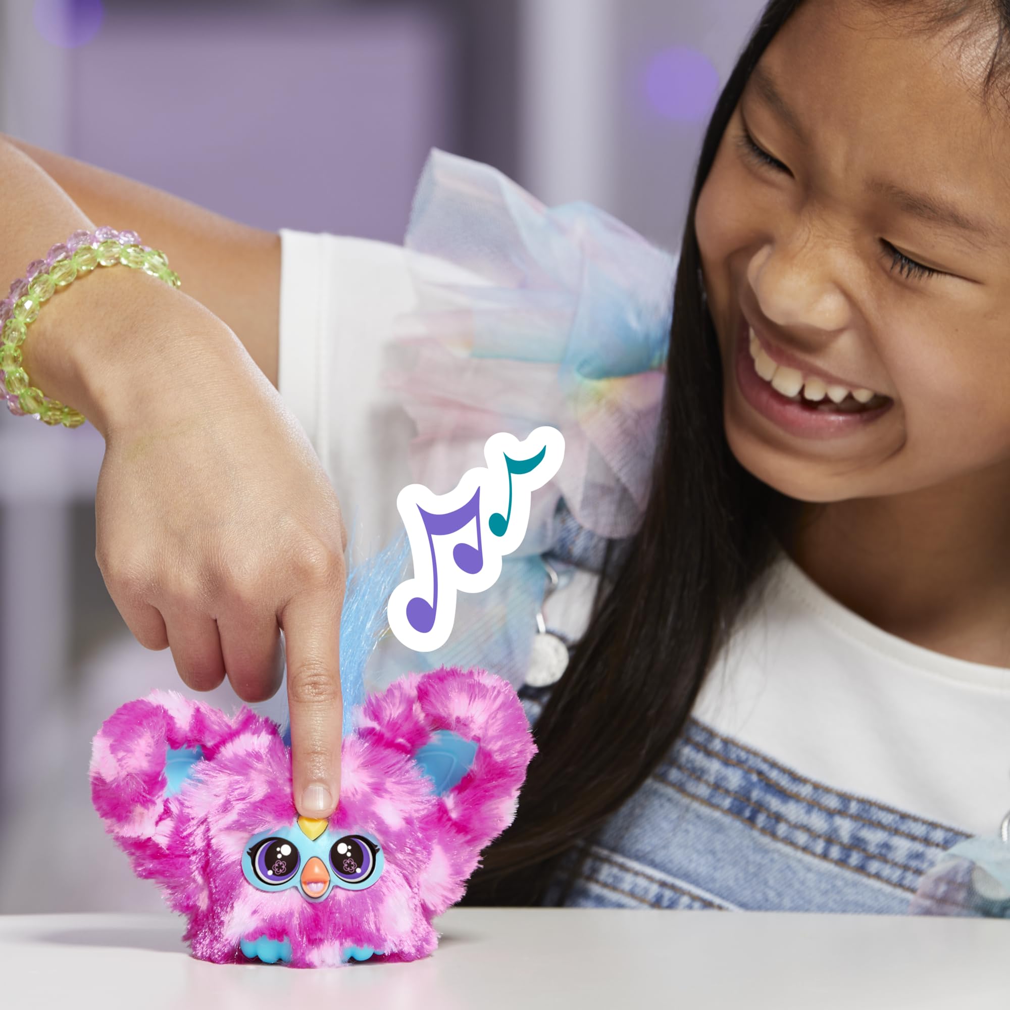 Furby Dah-Tee pairs with larger Furby sets to expand pretend-play options.