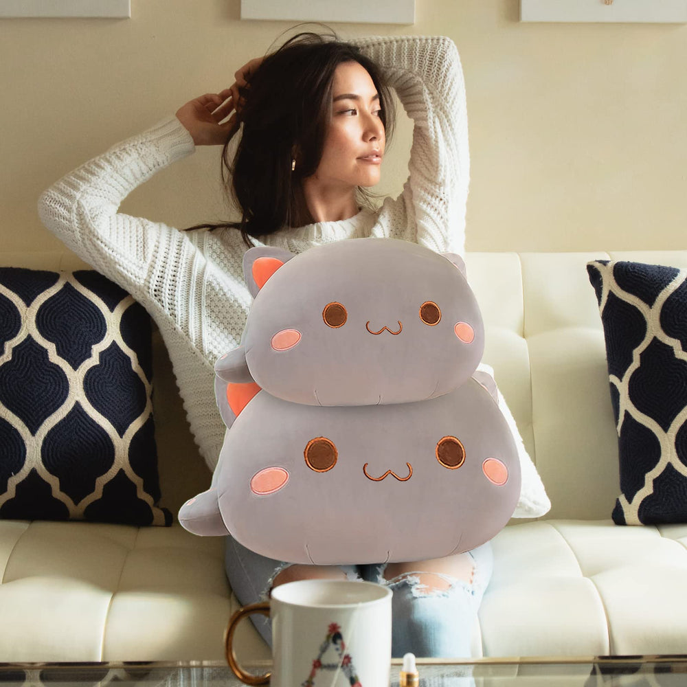 FUYU cat plush used as decorative accent on a sofa.