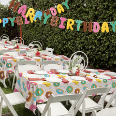Gatherfun donut tablecloth party backdrop idea enhances photos and ambiance.