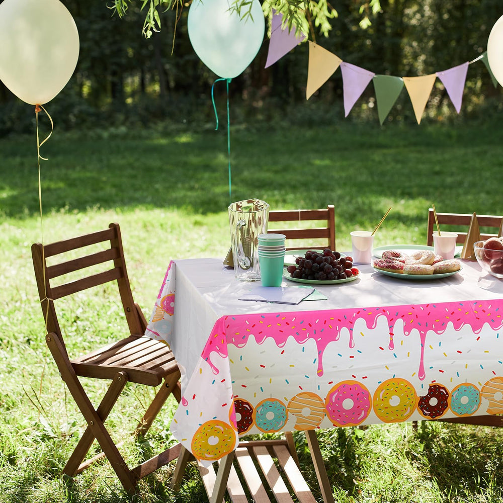 GGDE donut themed table cover used as a photo backdrop for birthday moments