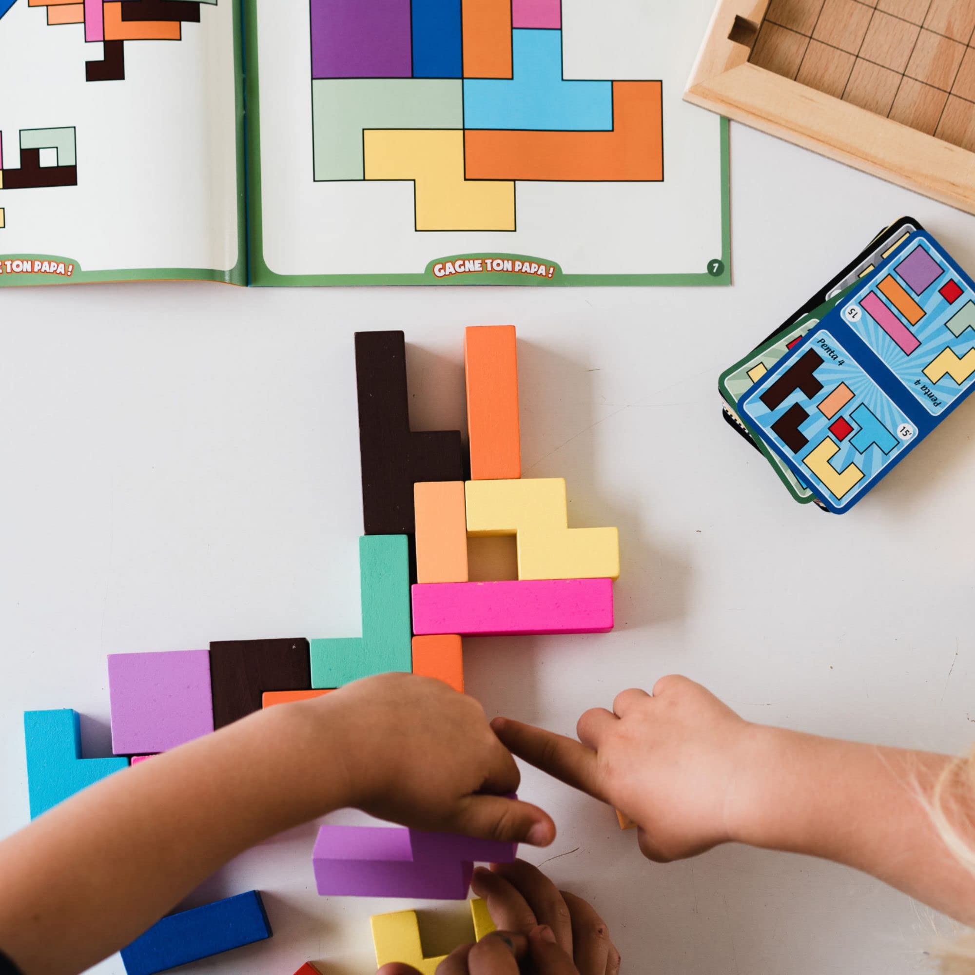 Gigamic Katamino Family colorful pentomino pieces on tray spark problem solving.
