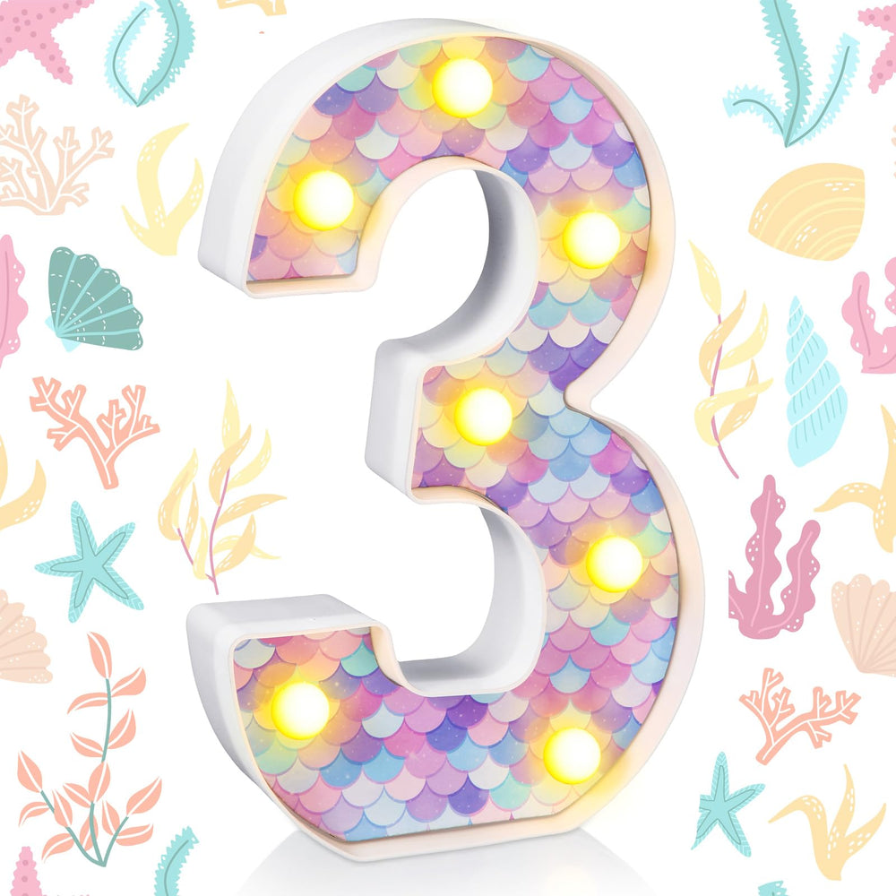 Glooglitter mermaid birthday light number 1 adds warm glow to centerpieces.