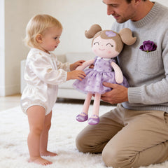 Gloveleya baby doll close-up shows purple flocking heart for gentle play.