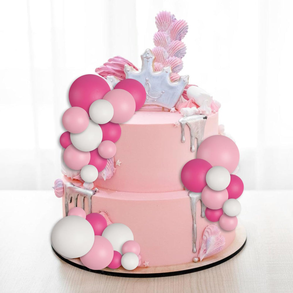 Goensjt white 4cm ball topper complements elegant wedding cake