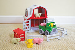 Green Toys Farm Playset fences help structure play scenes.