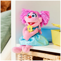 Holding a yellow flower Abby Cadabby plush adds cheerful display