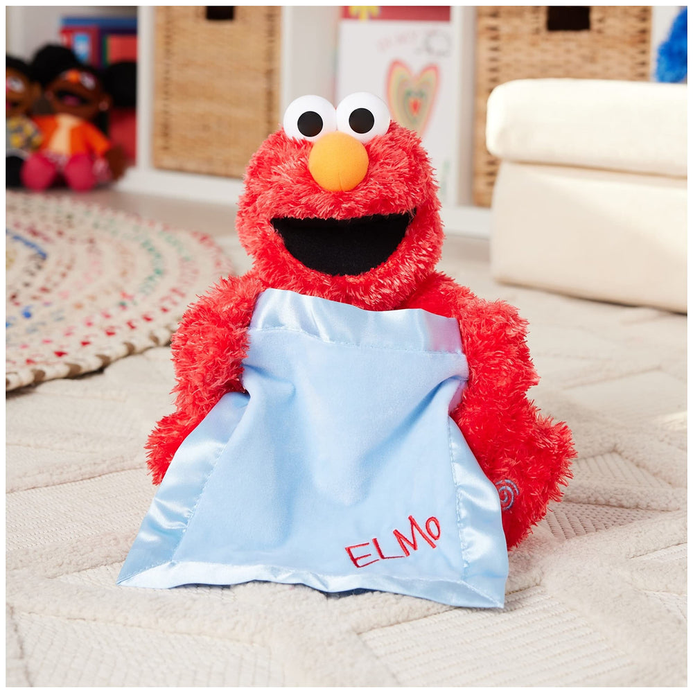 Elmo with blue satin blanket creates a soft visual cue during peek-a-boo moments.