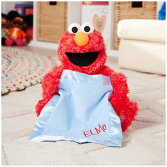 Elmo with blue satin blanket creates a soft visual cue during peek-a-boo moments.