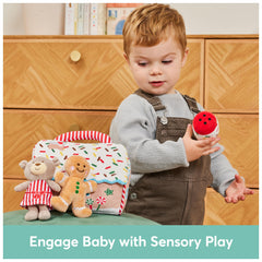 GUND frosting tube squeaker toy to engage sound and tactile play.