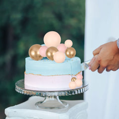 Gyufise ball cake topper in apricot gold provides safe decorative flair.