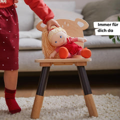 HABA Annelie doll with removable red dress for easy dressing.