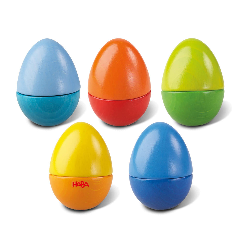 HABA Fun with Sounds wooden eggs in shake action promoting sensory exploration for toddlers.