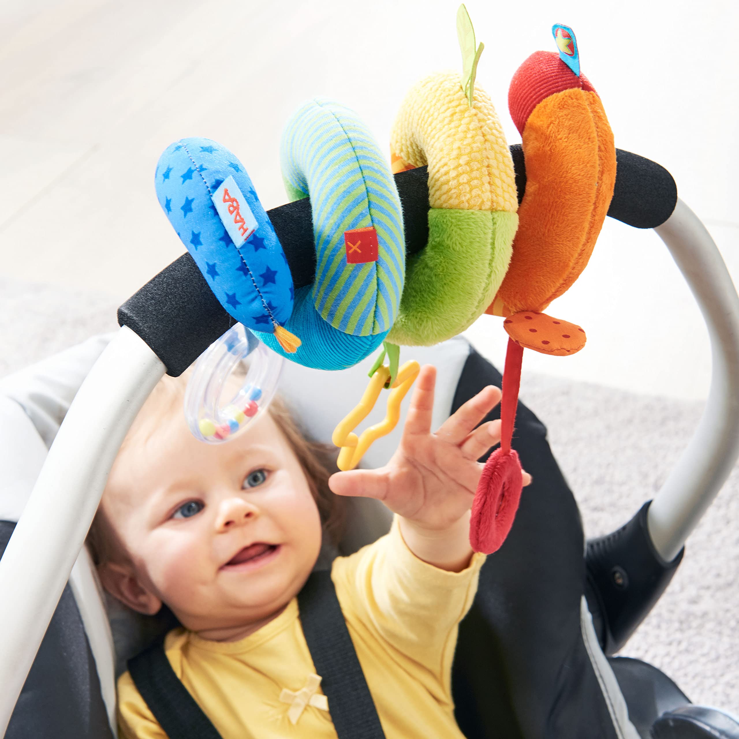 HABA Rainbow Activity Spiral rattle adds gentle sound cues during baby playtime