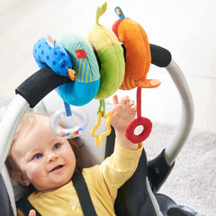 HABA Rainbow Activity Spiral teething-ring promotes soothing tactile exploration during trips