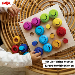 HABA Rainbow Whirls stacking-tower encourages hands-on learning through tall towers.