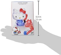 Hanayama Crystal Gallery Hello Kitty Telephone piece glows when illuminated on a shelf.