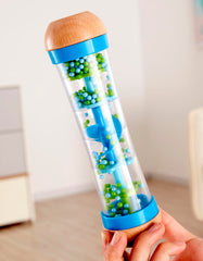 Hape rainmaker blue-green colors captivate children during visual tracking and musical curiosity.
