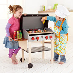 Hape Gourmet Grill glowing coals enhance immersive outdoor play.