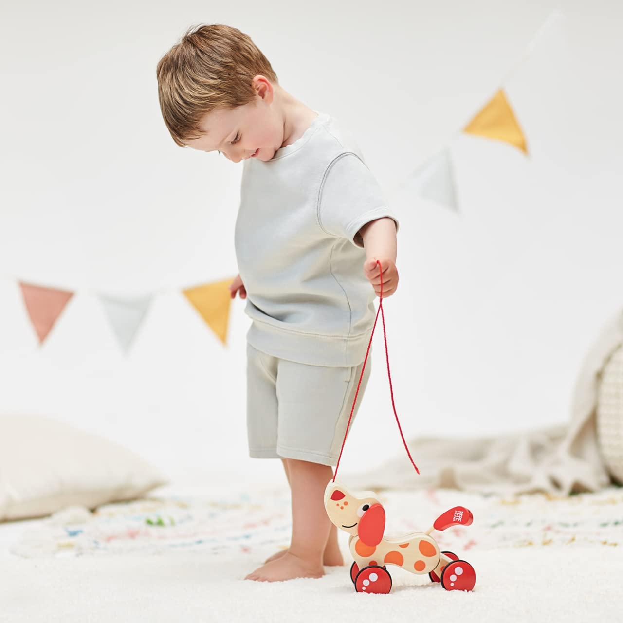 Hape Walk-A-Long Puppy being pulled by a child supports active play