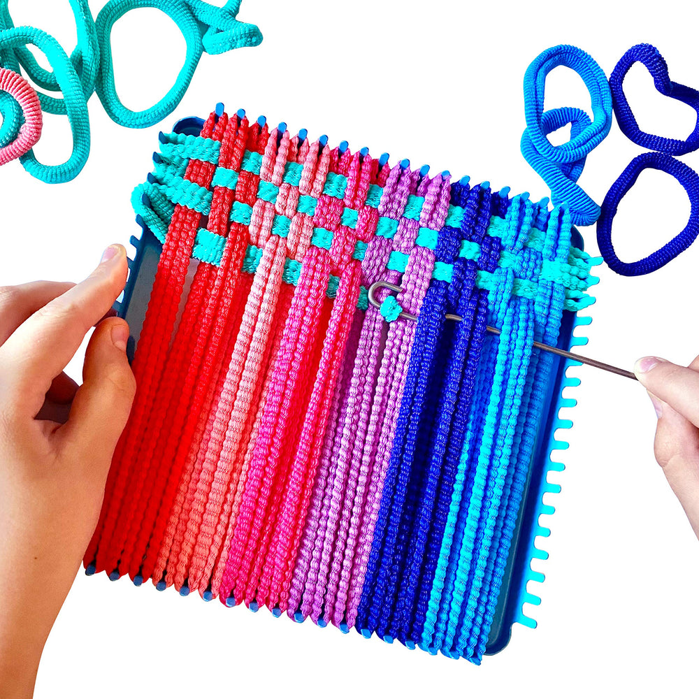 Hapinest child weaving potholder project in progress with bright loops