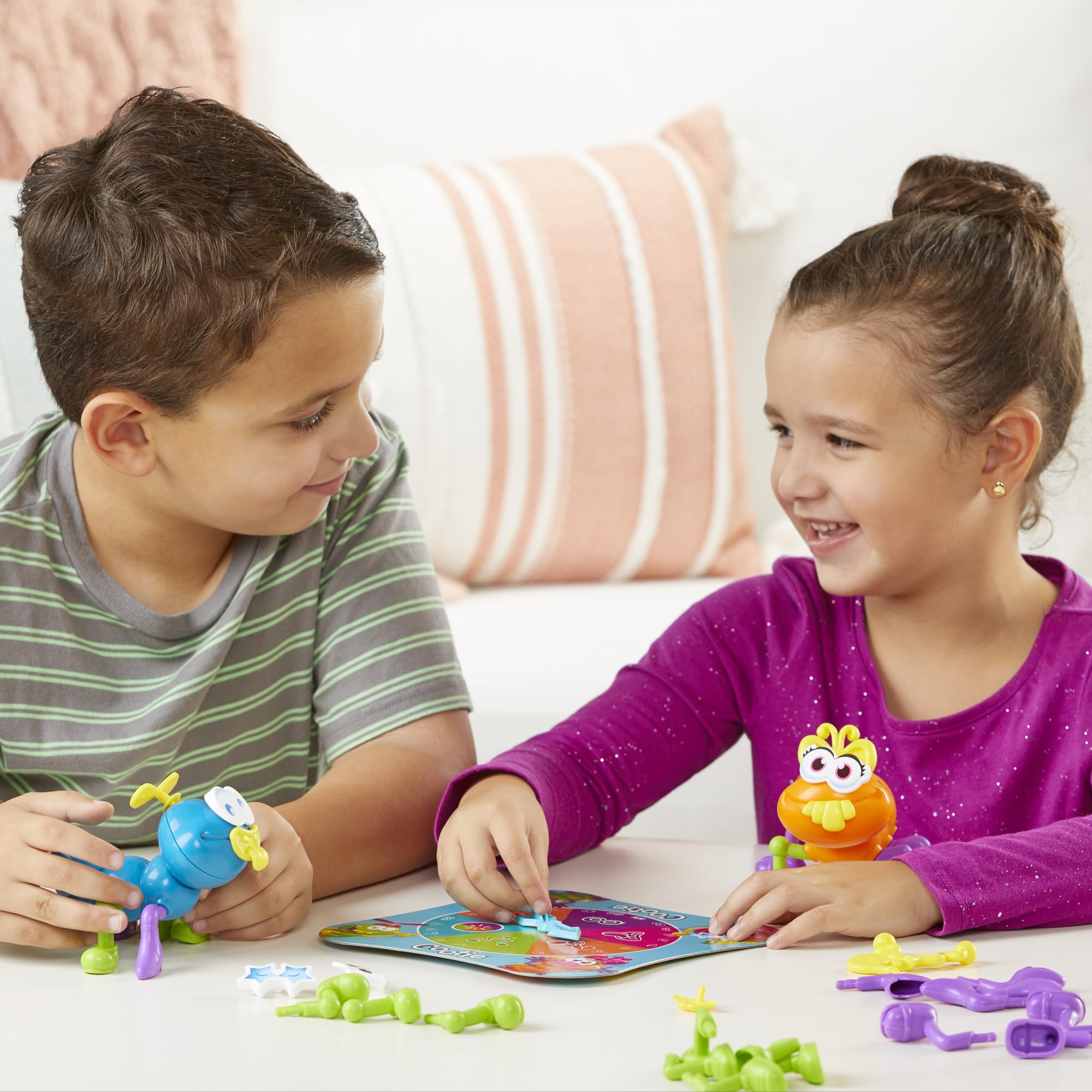Hasbro Gaming Cootie spinner in action driving creative building.