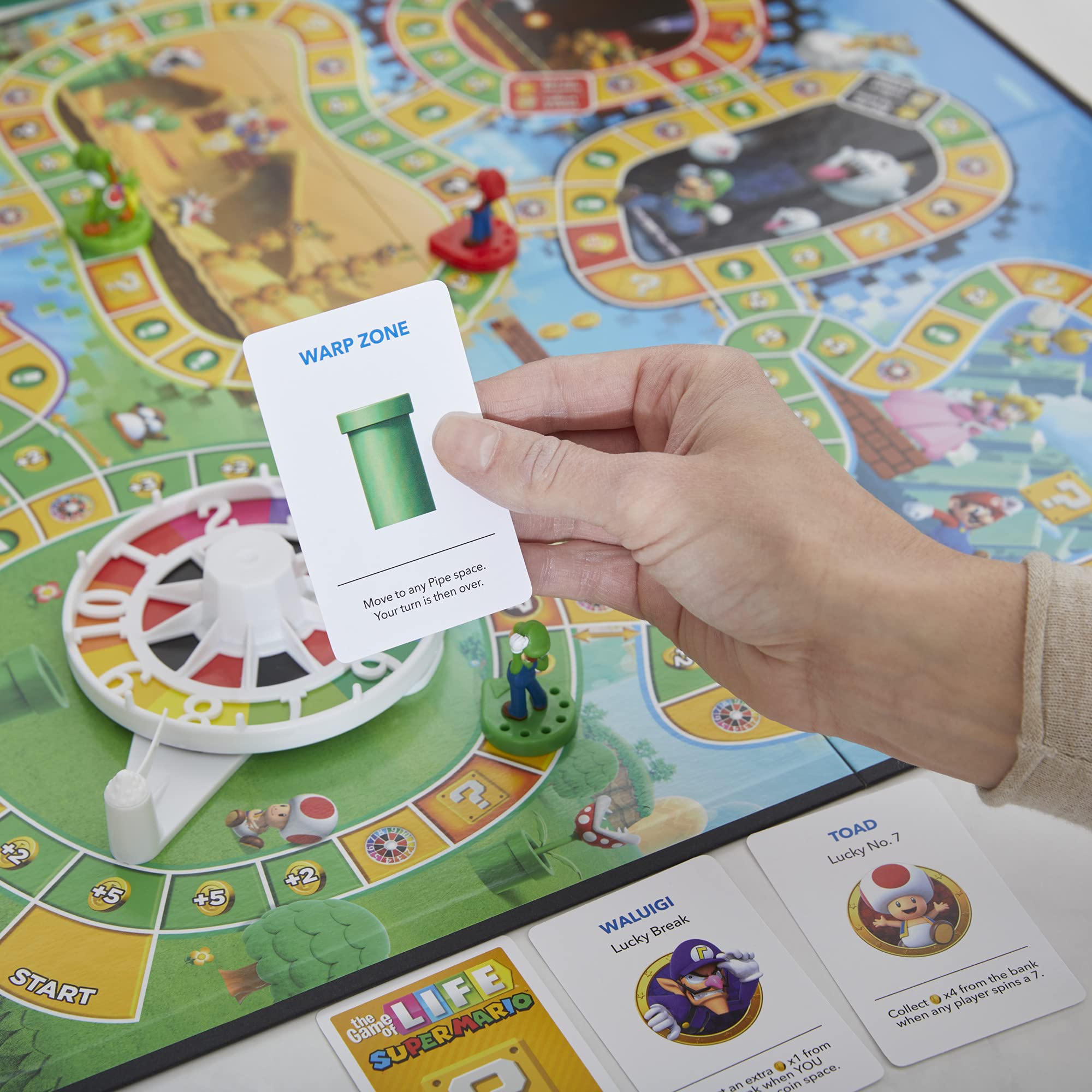 Hasbro Game of Life: Super Mario Edition spins determine Bowser duels and outcomes.
