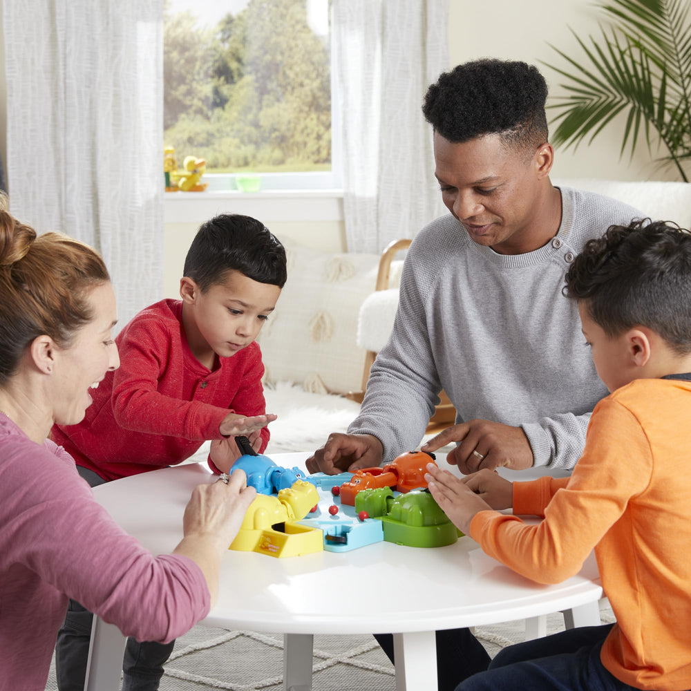 Hasbro Gaming Hungry Hungry Hippos box contents shown with marbles and hippos, easy setup.