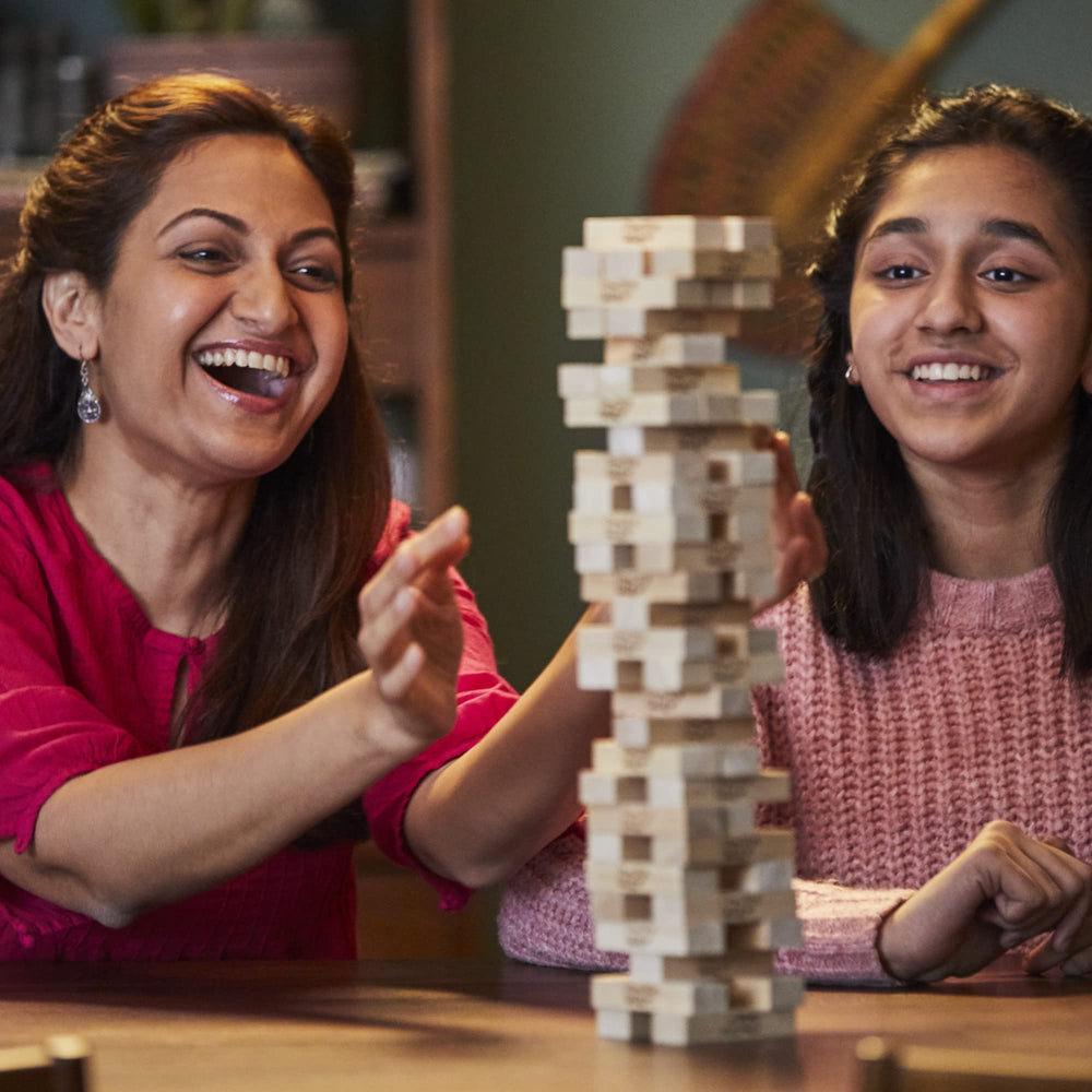 Hasbro Jenga blocks stacked neatly in a tower