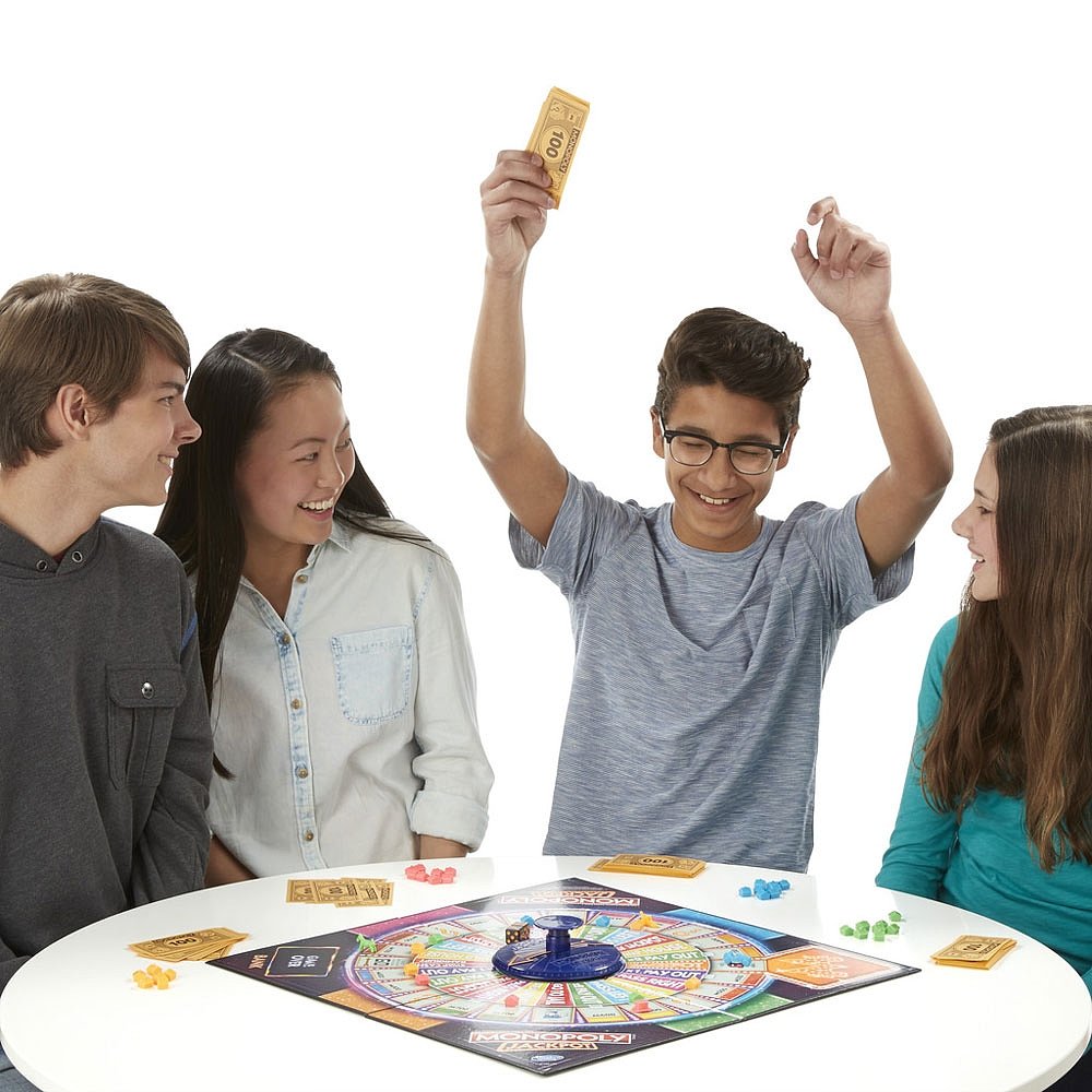 Hasbro Monopoly Jackpot player tokens and money close-up for friendly competition.
