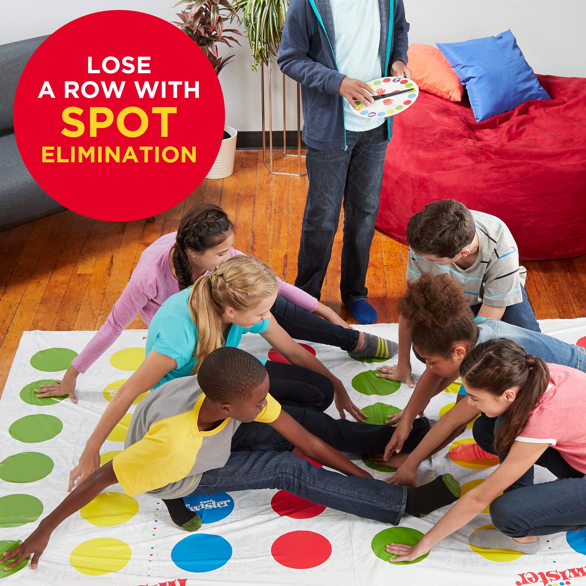 Hasbro Twister Ultimate spinner in action guiding moves on mat.