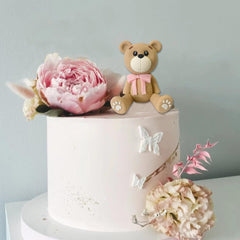 HAVAGDTM pink bear topper brings charm to animal-themed party tables.