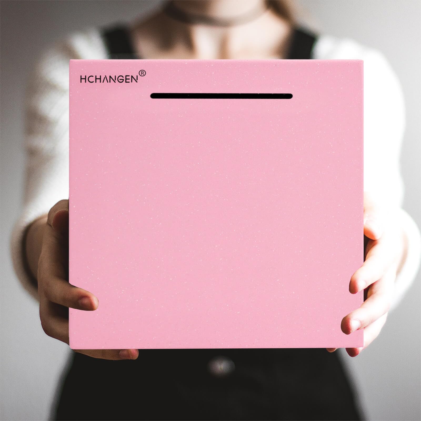 HCHANGEN piggy bank pink coins slot close-up highlights sealed design for disciplined saving.