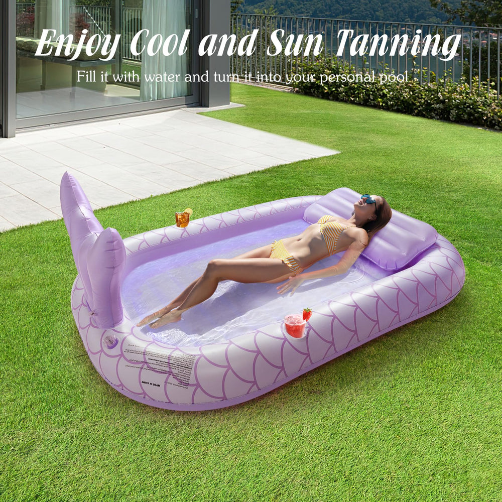 HeySplash inflatable tanning lounger purple, backyard setup for outdoor fun with friends.