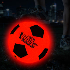 HITEGY glow-in-the-dark soccer ball during a kick for night play.