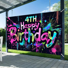 HOMETITUTE Neon 4th banner serves as a photo booth backdrop for vibrant celebrations