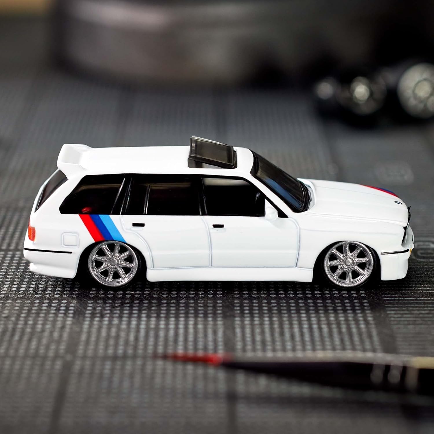 Hot Wheels Elite 64 BMW 318i Touring Real Riders wheels improve grip and authenticity.