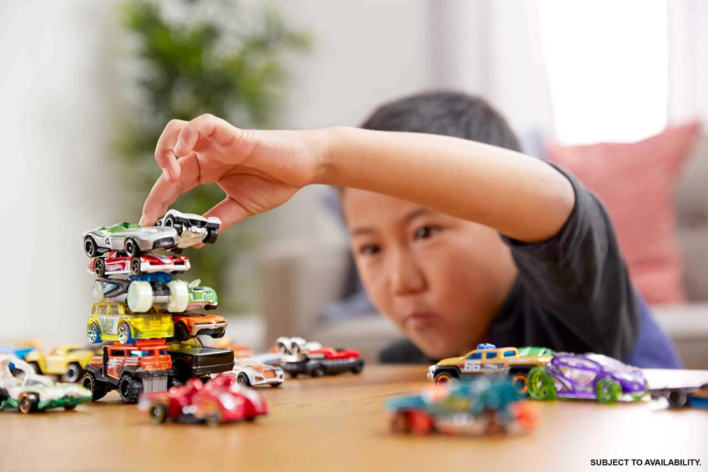 Hot Wheels diverse pack with race cars, trucks, and rescue vehicles for dynamic play.