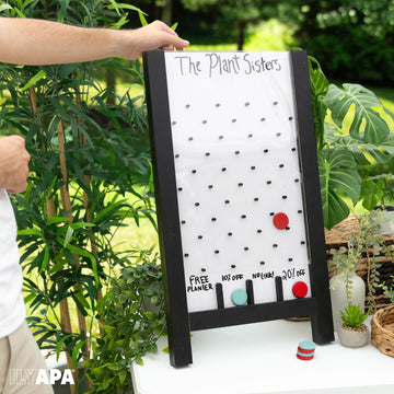 Booth setup shows attendee engagement with the Ilyapa prize drop activity.