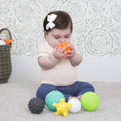 Infantino ball set used during supervised play on a soft mat