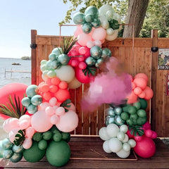 Isndare pastel green balloons pair with arches for tropical themes.