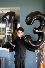 IWERP 13th birthday black foil balloon adds elegant focal point.
