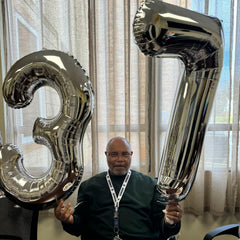 IWERP 7th birthday balloon serves as a photo backdrop for milestones.