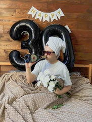 IWERP black 50th anniversary balloon complements black themed party decor.
