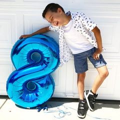 IWERP blue number 8 balloon enhances table decor and photo moments.