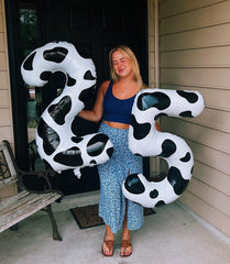 IWERP cow print backdrop prop enhances photo opportunities.