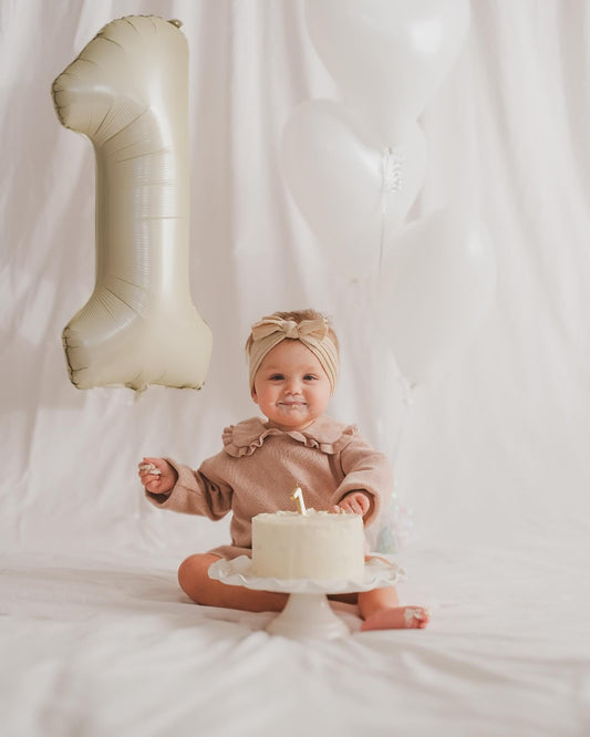 IWERP First birthday balloon in cream offers elegant decor for baby and family celebrations.