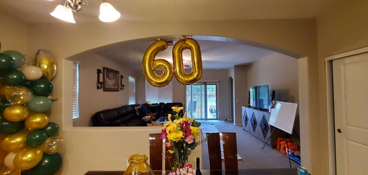 IWERP gold 60th birthday decor backdrop creates a luxurious party focal point.