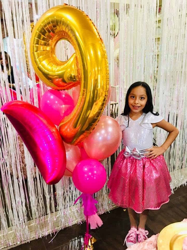 IWERP gold balloon decor enhances party ambiance and photo opportunities.